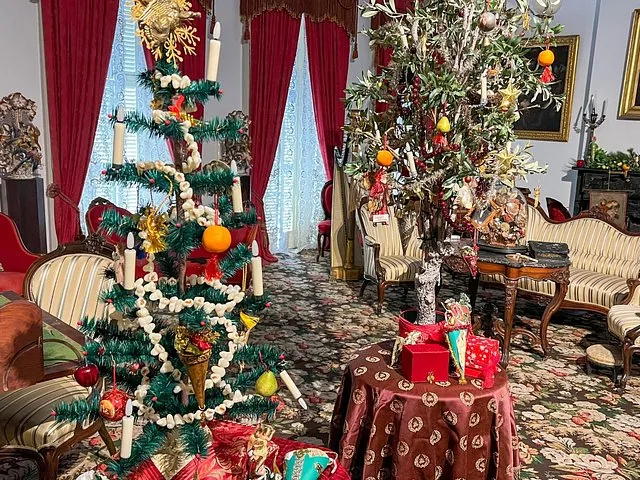 A room decorated for the holidays, featuring small, uniquely adorned trees.