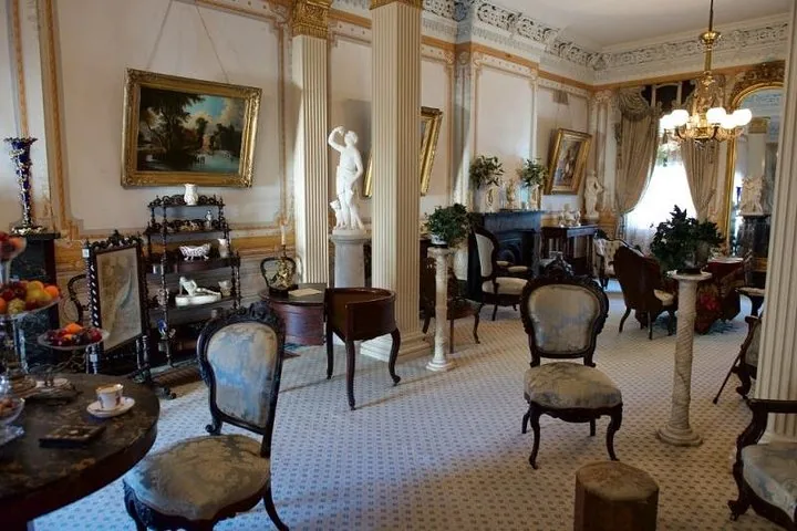 Another view of the lavishly decorated parlor with a white marble statue.